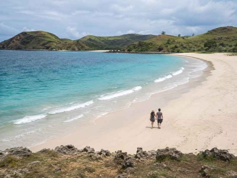 Lombok 4D3N package booking with a couple exploring Tanjung Aan Beach
