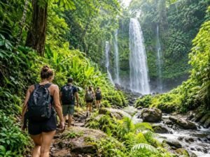 Lombok waterfall day trip with travelers walking through green scenery