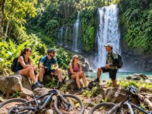 Cyclists taking a break near a waterfall in North Lombok