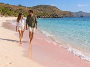 Couple enjoying the softly tinted sand at Tangsi Beach Lombok
