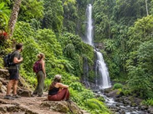 Visitors enjoying the forest surroundings at Sendang Gile Waterfall in Lombok